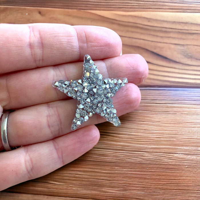 Love 3.5cm sparkling silver rhinestone iron-on star patch in a hand