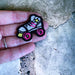 White roller skate embroidered iron on patch shown in a hand for size