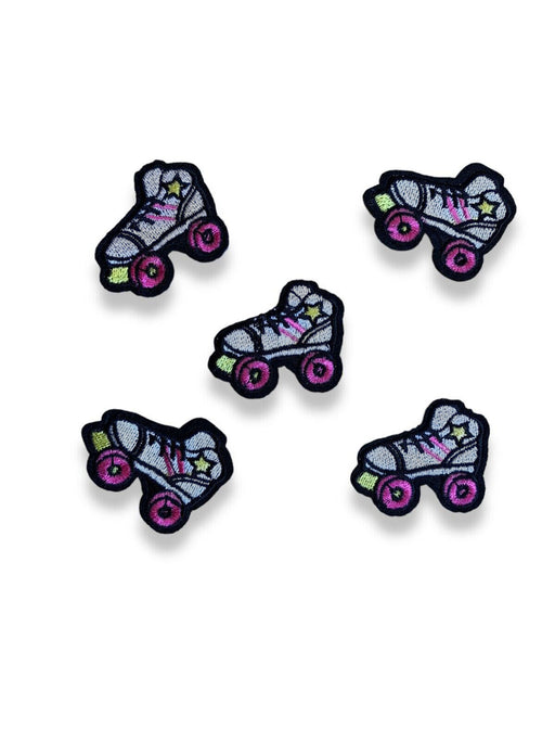 White embroidered roller skate iron on patches with pink wheels, yellow stars and toe stoppers