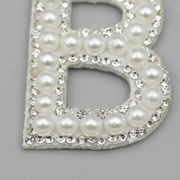 White pearl silver rhinestone iron-on patch letters showing a close-up of the letter B.