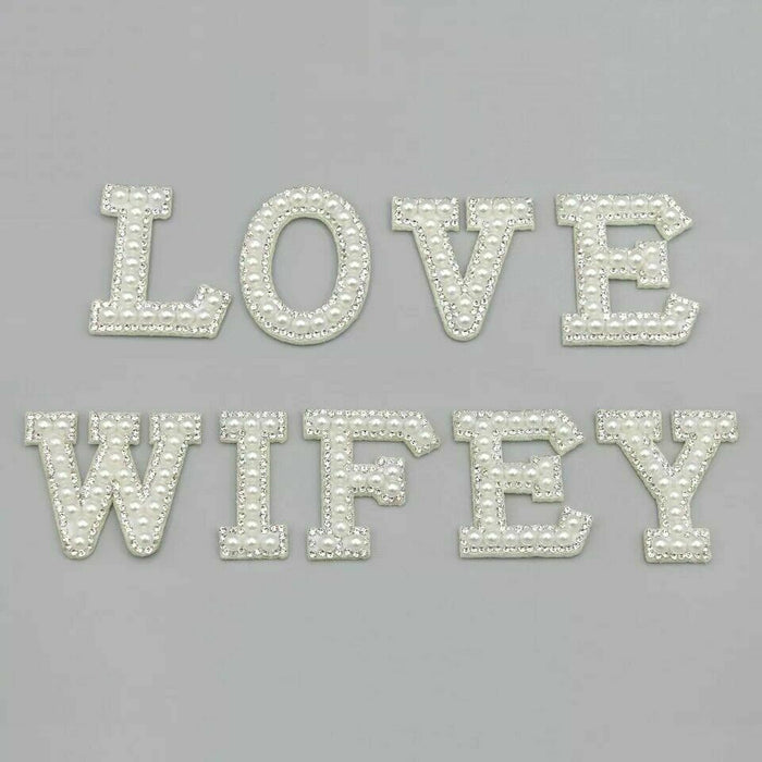 White pearl silver rhinestone iron-on patch letters showing the words LOVE WIFEY..